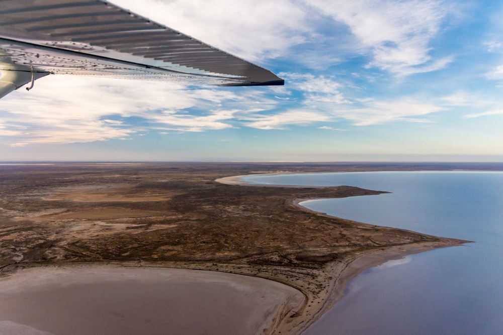 wing of plane flying over lake eyre
